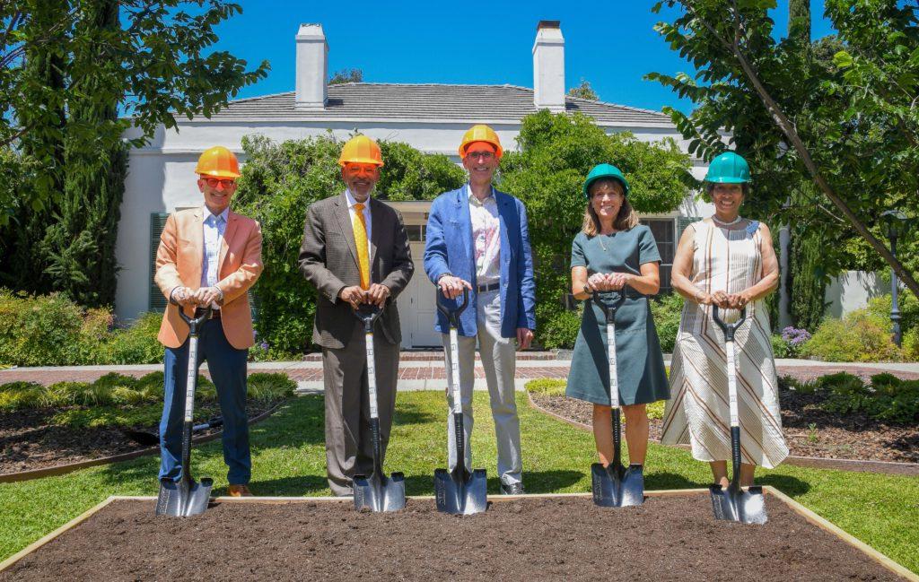 Five people wearing hard hats holding shovels at the Nucleus groundbreaking ceremony